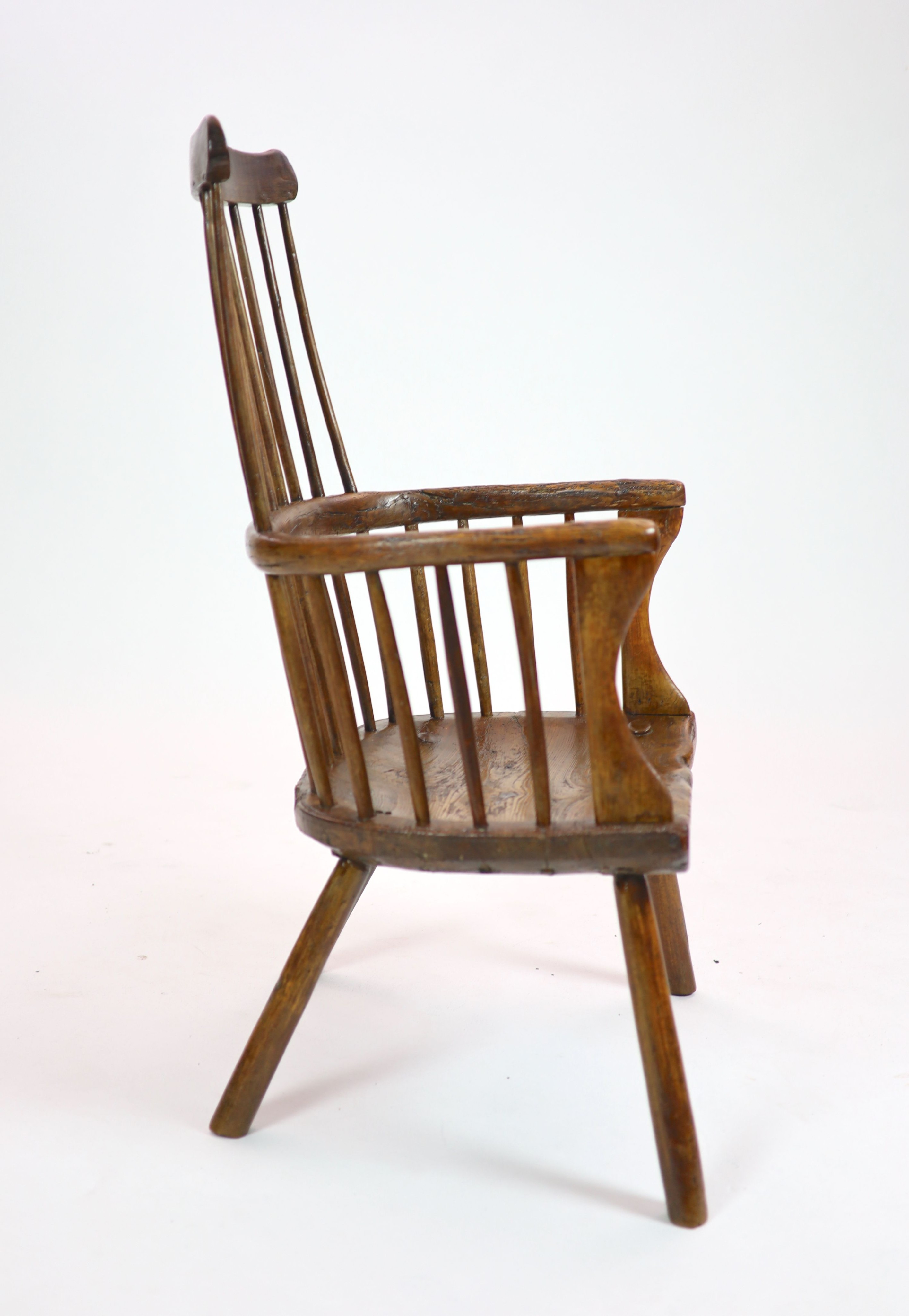 An 18th century West Country elm and fruitwood primitive armchair H 105cm. W 60 cm. D 58cm.